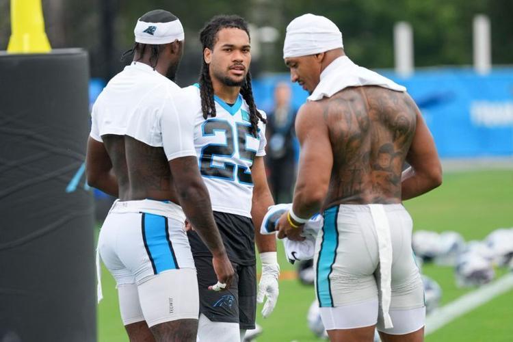 Aug 4, 2026; Charlotte, NC, USA; Carolina Panthers wide receiver Xavier Legette (17), running back Jonathon Brooks (25) and running back Chuba Hubbard (30) chat during training camp at Bank of America Stadium. Mandatory Credit: Jim Dedmon-Imagn Images