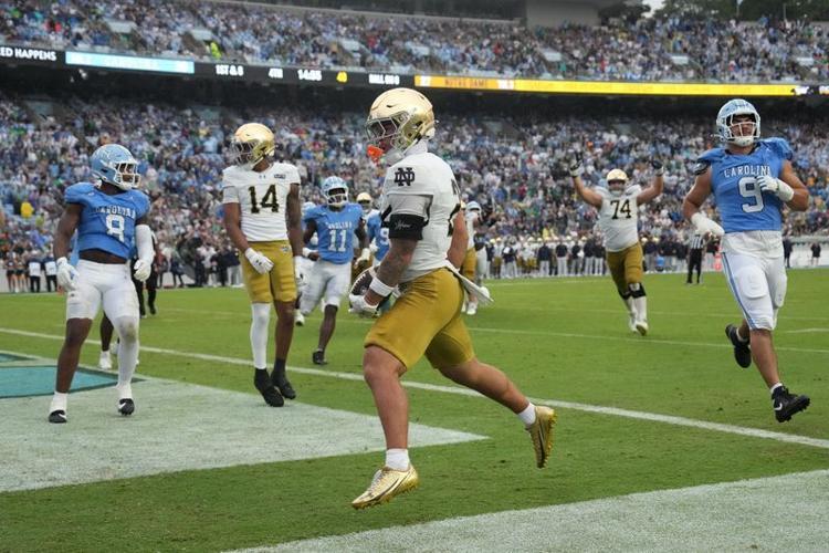 Oct 3, 2026; Chapel Hill, North Carolina, USA; Notre Dame Fighting Irish running back Nolan James Jr. (2) socres a touchdown as North Carolina Tar Heels linebacker Jonathan Agumadu (8) and defensive lineman Melkart Abou Jaoude (9) defend in the second h...