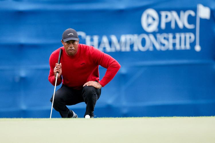 Tiger Woods lines up a putt on a playoff hole during the 2024 PNC Championship at The Ritz-Carlton Golf Club.