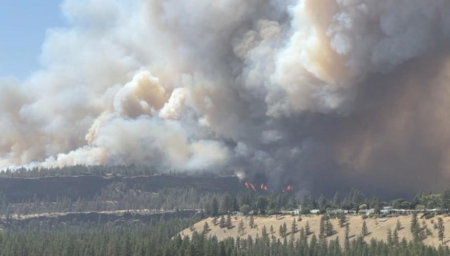 FILE PHOTO: Massive plumes of smoke rise from a wildfire in Spokane