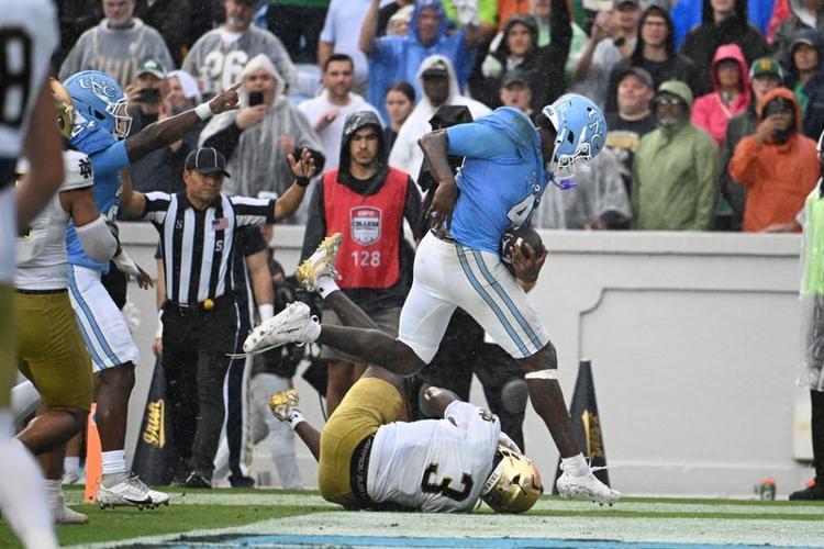 Oct 3, 2026; Chapel Hill, North Carolina, USA; North Carolina Tar Heels tight end Jelani Thurman (45) scores a touchdown as Notre Dame Fighting Irish linebacker Jaylen Sneed (3) defends in the second half at Kenan Stadium. Mandatory Credit: Bob Donnan-I...