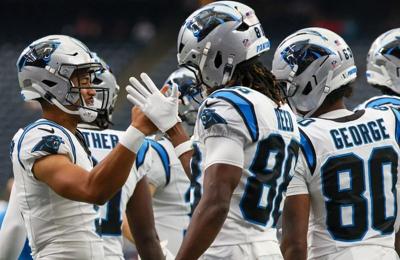Aug 16, 2025; Houston, Texas, USA; Carolina Panthers quarterback Bryce Young (9) high fives wide receiver Ja'seem Reed (88) and teammates before playin g against the Houston Texans at NRG Stadium. Mandatory Credit: Thomas Shea-Imagn Images