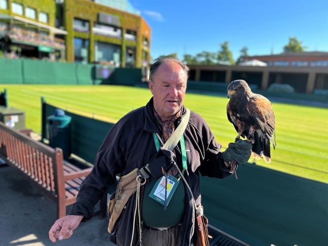 Wayne Davis strolls with Rufus around an outer court at the All England Lawn Tennis& Croquet Club.