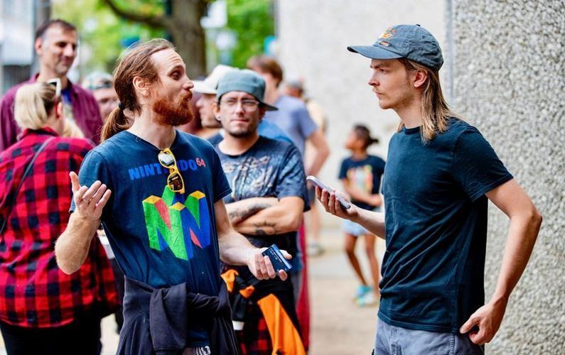 Asheville Citizen Times Growth and Development Reporter Will Hofmann interviews Asheville residents waiting in line for access to the ATM at Wells Fargo along Haywood Street in downtown Asheville the morning of Sept. 29. Tropical Storm Helene landed in ...