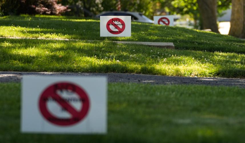 Signs seen in a downtown Mason yards against data centers, Tuesday, June 2, 2026.