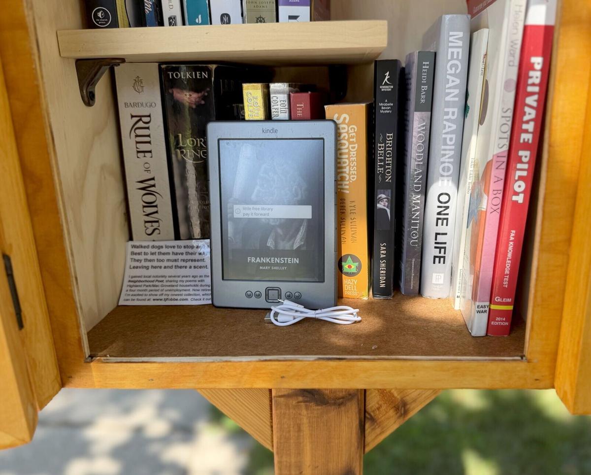 A Little Free Library belonging to Abe Eyman of St. Paul shows the usual printed-book fare on Aug. 9, 2026, along with an Amazon Kindle e-reader Eyman has outfitted with dozens of e-books for free distribution via the book station.