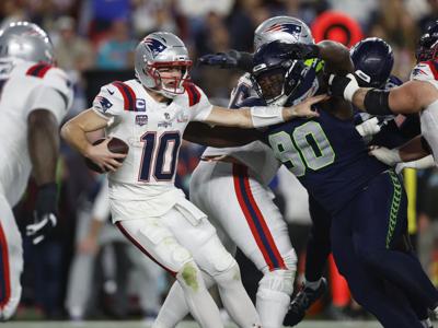 New England Patriots quarterback Drake Maye is tackled by Seattle Seahawks' Jarran Reed in the third quarter of Super Bowl LX at Levi's Stadium in Santa Clara, California, on Sunday, Feb. 8, 2026.