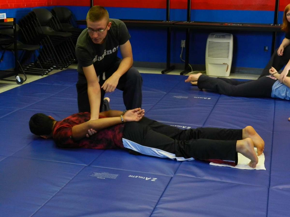 Law and Justice students practice handcuff techniques