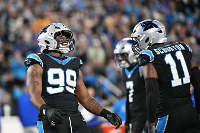 Jan 10, 2026; Charlotte, NC, USA; Carolina Panthers defensive tackle Tershawn Wharton (99) reacts with linebacker Nic Scourton (11) in the third quarter in an NFC Wild Card Round game at Bank of America Stadium. Mandatory Credit: Bob Donnan-Imagn Images