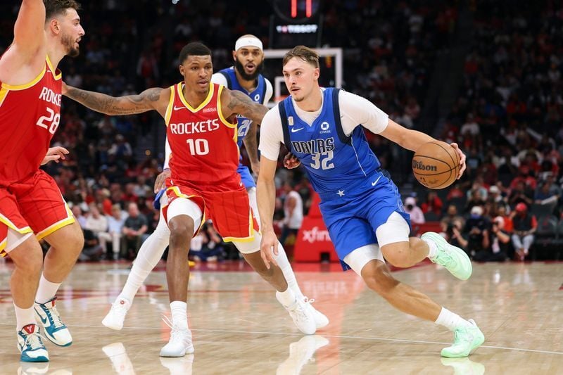 Oct 21, 2026; Houston, Texas, USA; Dallas Mavericks forward Cooper Flagg (32) dribbles the ball as Houston Rockets center Alperen Sengun (28) defends during the third quarter at Toyota Center. Mandatory Credit: Troy Taormina-Imagn Images