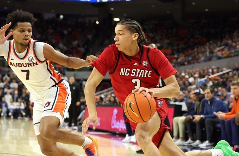 Dec 3, 2025; Auburn, Alabama, USA; NC State Wolfpack guard Matt Able (3) drives against Auburn Tigers guard Keyshawn Hall (7) during the first half at Neville Arena. Mandatory Credit: John Reed-Imagn Images