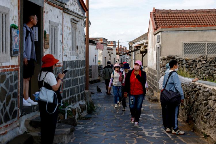 Tourists visit Erkan Historical Village, in Penghu