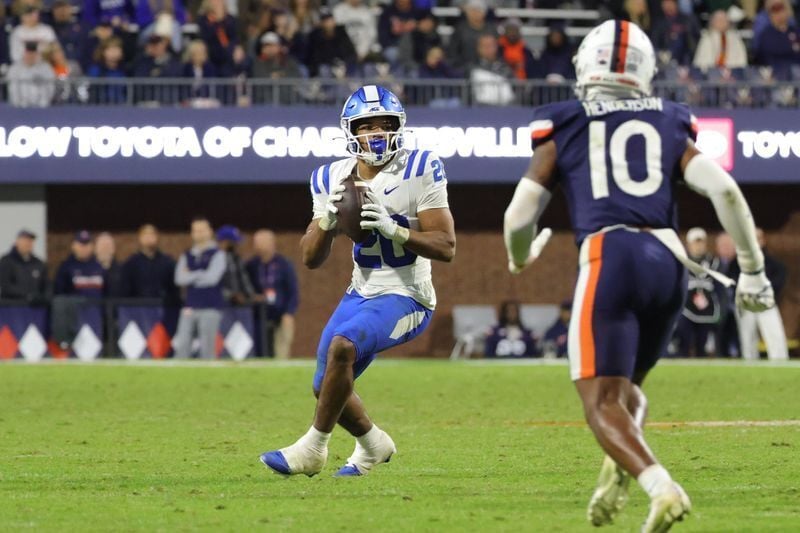 Oct 23, 2026; Charlottesville, Virginia, USA; Duke Blue Devils running back Nate Sheppard (20) throws the game-winning touchdown pass against the Virginia Cavaliers during the second half at Scott Stadium. Mandatory Credit: Amber Searls-Imagn Images