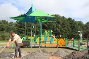 Safety Village installing astroturf to complete inclusive playground