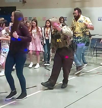 School resource officer Jon Cline shown dancing in the McGregor auditorium
