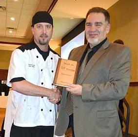 David Downing, executive director of Kinship Partners, (right) presents Sam Shaw with his  award for “best dessert.