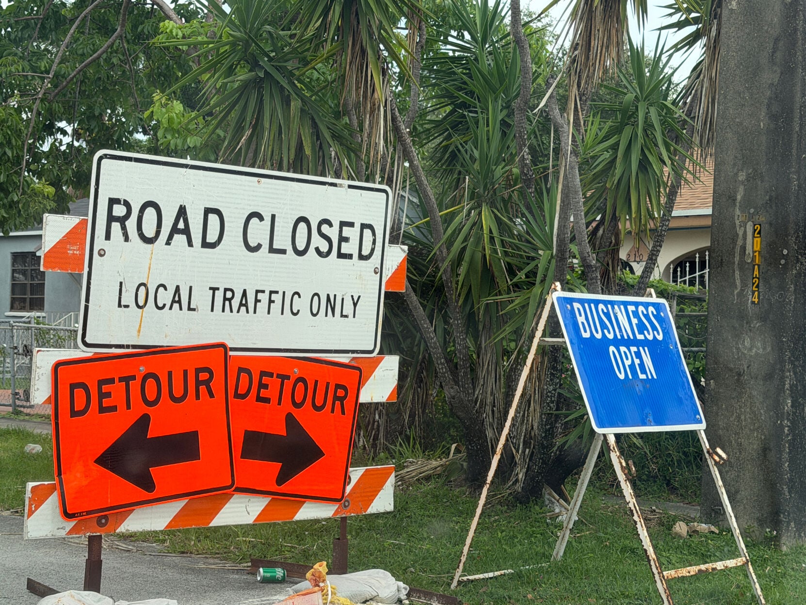 Road closure and detour signs near the construction area on Northwest 22nd Avenue