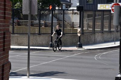 Young bicyclist waits at crosswalk
