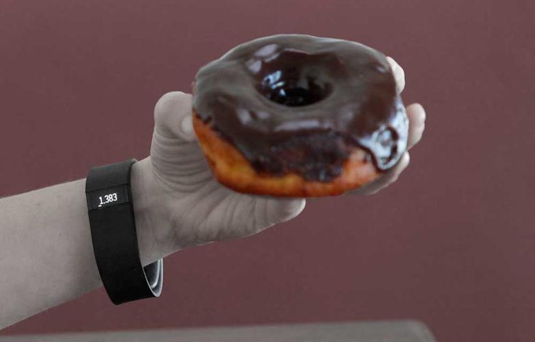A trial of fitness measurement devices leads a reporter to eat more donuts.
