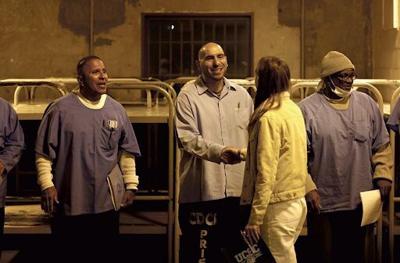 Inmates and the visitors shake hands