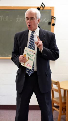 Sammy Oakey of the Rotary Club of Roanoke reading to preschoolers at Covenant Presbyterian Church