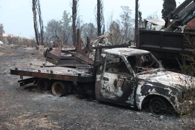 The charred remains of a pickup truck burned by the Pfeiffer Fire