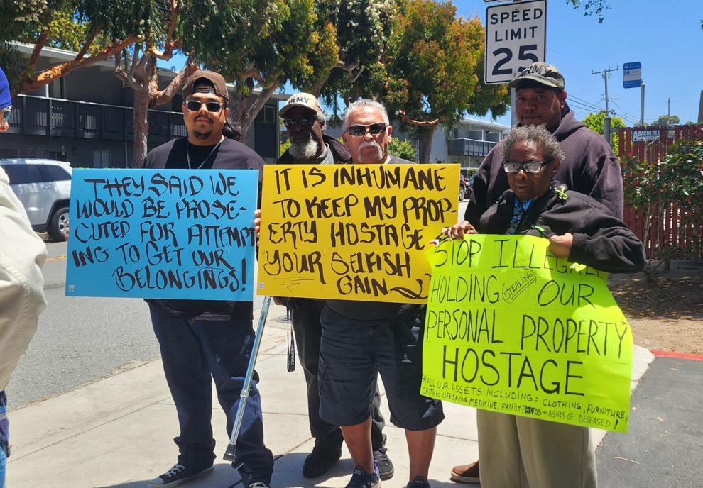 Months after the fire, displaced residents of Casanova Plaza gather outside the vacant complex to demand their possessions.