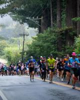 San Francisco runner defends Big Sur marathon crown as thousands take on the Highway 1 course.