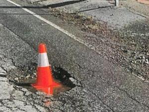 Image for display with article titled Storm-damaged county roads lead to more complaints, legal claims over potholes.