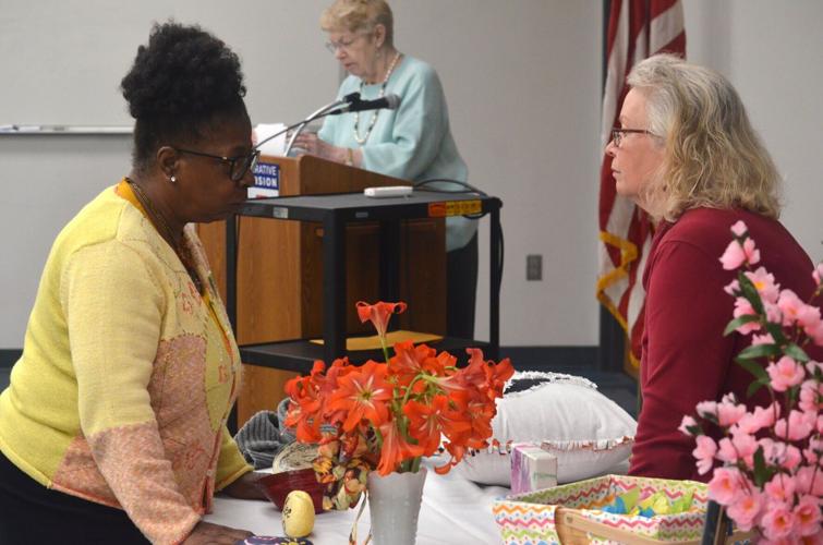 Cheryl Barrett speaks with an ECA member during Iredell County Extension and Community Association's Achievement Day at the Iredell County Center in Statesville.