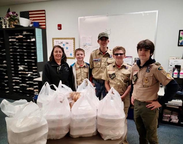 New scouts receive uniforms, donate food