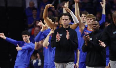 Florida coach Todd Golden celebrates in front of his bench during the Texas at Florida NCAA basketball game at the O’ Connell Center in Gainesville on Jan.18, 2025..