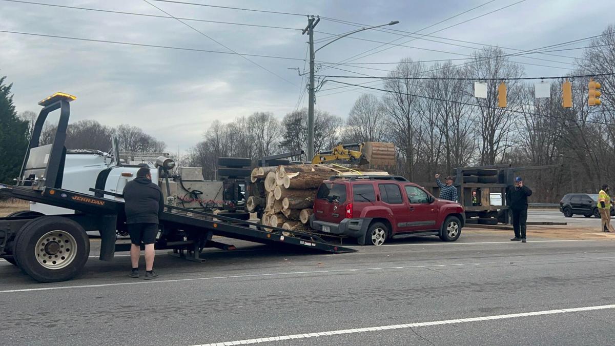 Logging truck overturns, spills logs on Burkemont Avenue in Morganton