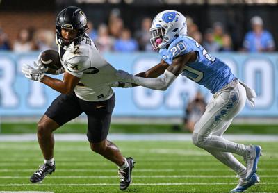 Tayon Holloway of the North Carolina Tar Heels attempts to tackle Kaedin Robinson of the Appalachian State Mountaineers during the game at Kenan Memorial Stadium on Sept. 9, 2023, in Chapel Hill, North Carolina.