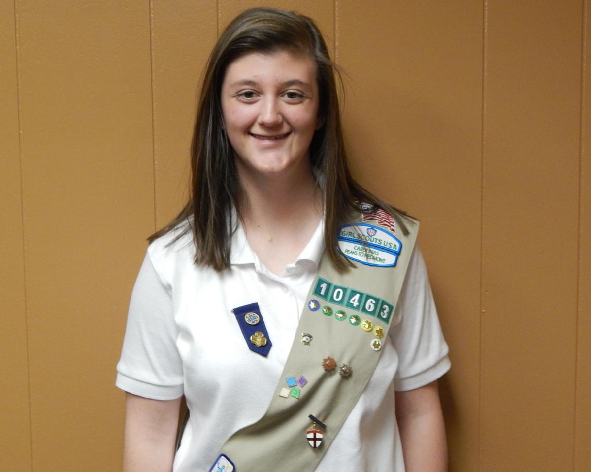 GOING FOR GOLD Girl Scout works to support band program 