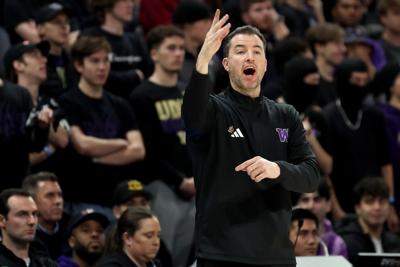 Washington head coach Danny Sprinkle reacts during the first half against Washington State at Alaska Airlines Arena on Dec. 18, 2024, in Seattle.