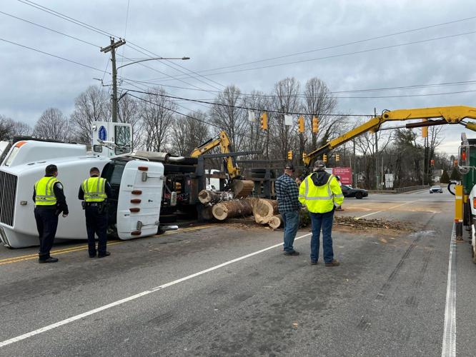 Logging truck overturns, spills logs on Burkemont Avenue in