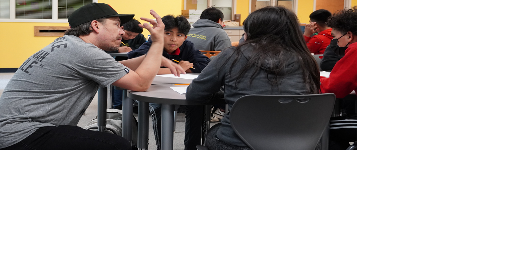 Poet Joaquin Zihuatanejo speaks to Burke middle schoolers
