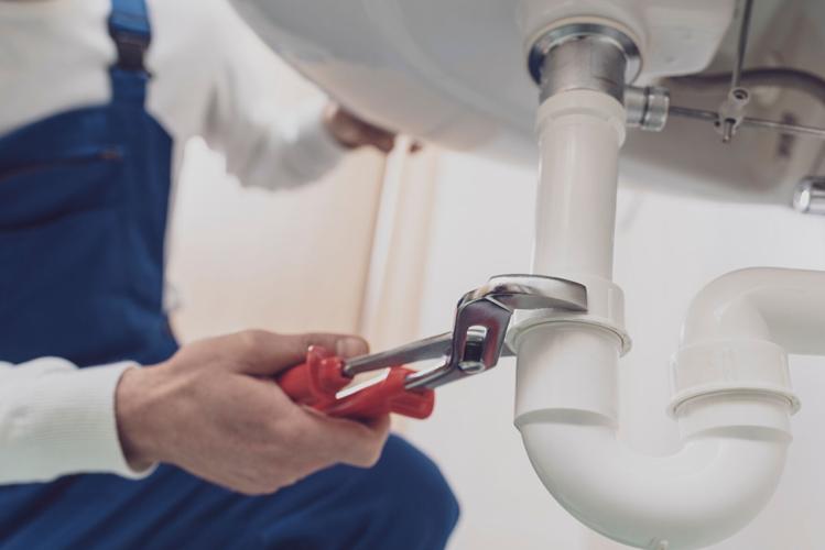 Plumber fixing a sink