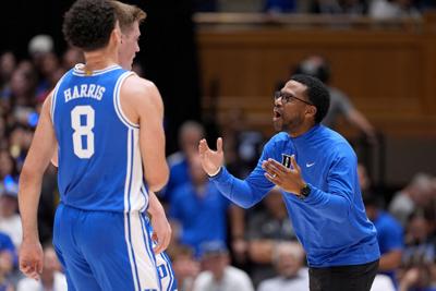 Duke assistant coach Jai Lucas talks with Darren Harris and Kon Knueppel during Countdown to Craziness at Cameron Indoor Stadium on Oct. 4, 2024, in Durham, North Carolina.