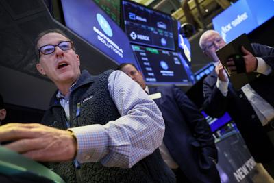 Traders work on the floor of the NYSE in New York