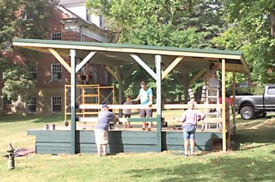 Volunteers help paint Mayfest stage