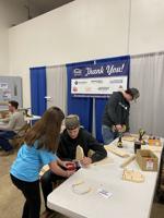 Workforce Development booth with a young future builder.jpg