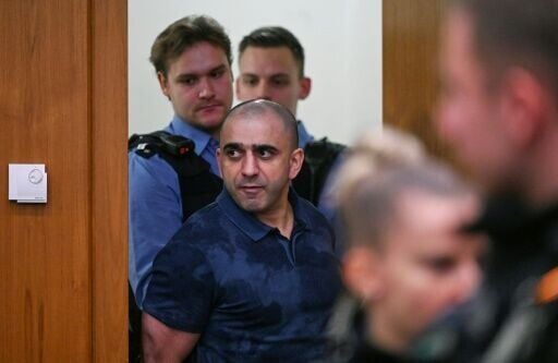 Co-defendant Arman S. is led into the courtroom for the start of the trial
