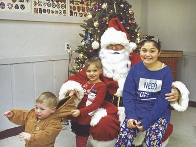 Arnold Baum of De Soto sent in this photo of himself playing Santa, along with his great-grandchildren, from left, Marshall Baum, Amelia Baum and Marianna Mooney.