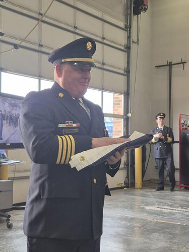 Rock Community Fire Protection District Assistant Chief Chuck Hill received an American flag during his flag ceremony. Hill retired after 39 years with the district.