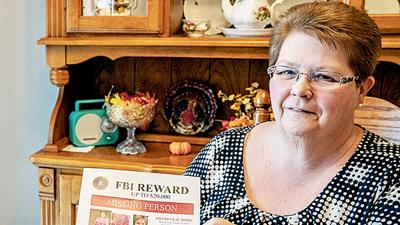 Bertha Propst in 2018 with a flyer offering a reward for information about her daughter, Amanda Jones.