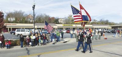 Two color guard members lead the 2017 De Soto Veterans Day Parade.