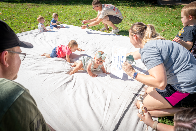 Carolyn Holmes, 10 months, of Festus leads the pack during the baby crawling contest with Eloise Cagle, 10 months, of Festus close behind.
