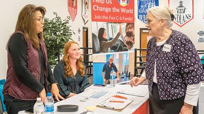 Mary Chrapek of Arnold, right, discusses substitute teaching openings with Fox C-6 School District representatives Monica Montgomery, left, and Reagan Mullins during the Jefferson County Job Fair on  Oct. 19 at the Fox C-6 Service Center in Arnold.